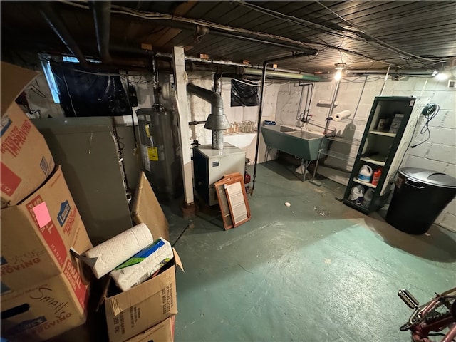 basement with water heater and sink