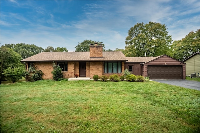 ranch-style house with a front yard and a garage