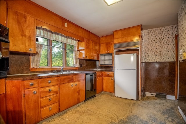 kitchen with black dishwasher, sink, and white refrigerator