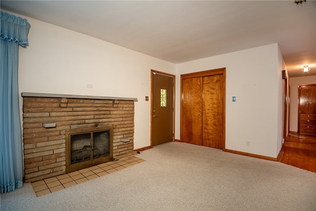 unfurnished living room with light carpet and a fireplace