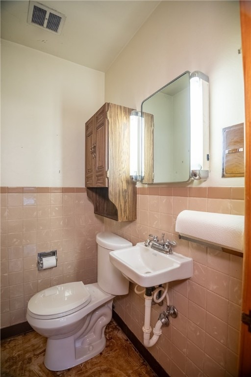 bathroom featuring tile walls, tile patterned flooring, sink, and toilet