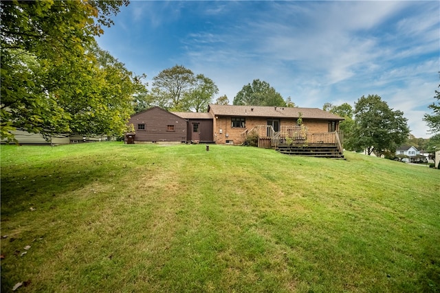 back of property featuring a deck and a yard