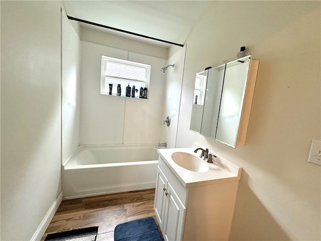 bathroom with tub / shower combination, vanity, and hardwood / wood-style flooring