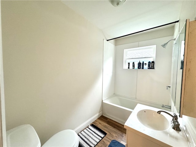 full bathroom with tub / shower combination, vanity, hardwood / wood-style floors, and toilet