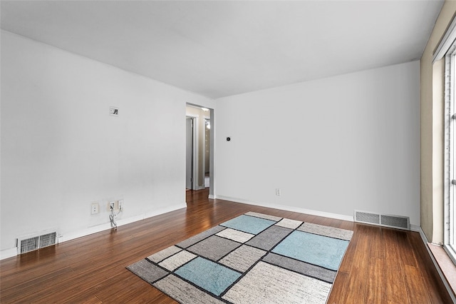 empty room featuring dark hardwood / wood-style flooring