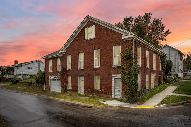 property exterior at dusk featuring a garage