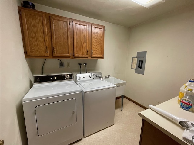 washroom with washer and clothes dryer, electric panel, sink, and cabinets