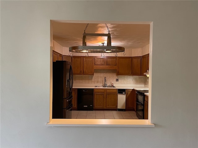 kitchen with ventilation hood, sink, black appliances, backsplash, and light tile patterned floors