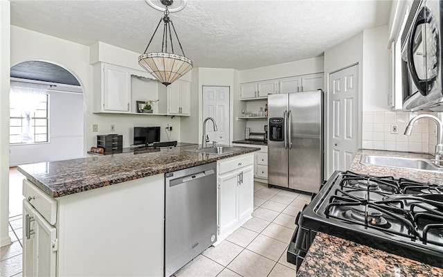 kitchen featuring stainless steel appliances, sink, and white cabinetry