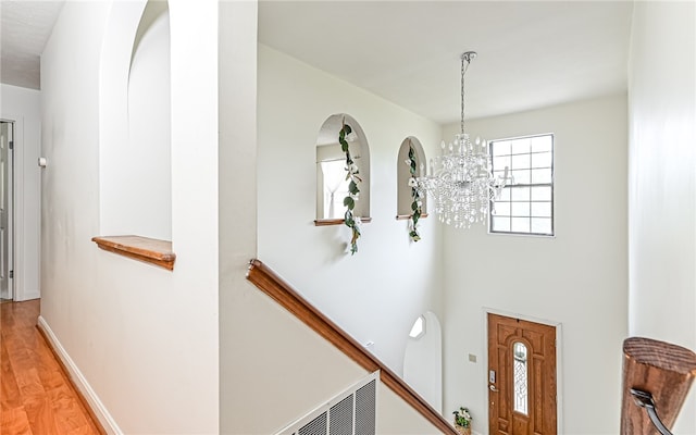 interior space featuring a notable chandelier and wood-type flooring