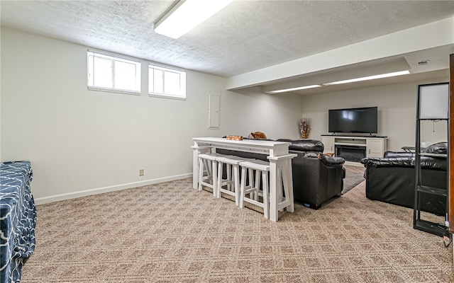 living room featuring light carpet and a textured ceiling