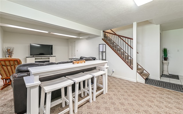 interior space with light colored carpet and a textured ceiling