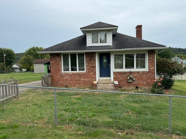 bungalow-style home with a front yard