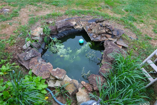 exterior details with a garden pond