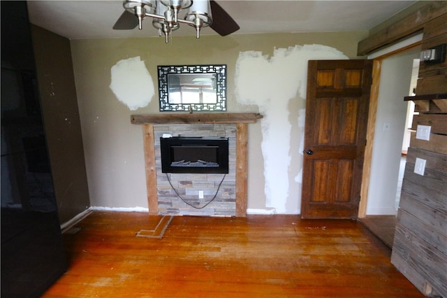 unfurnished living room with wood-type flooring and ceiling fan