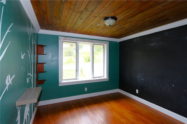 unfurnished room featuring hardwood / wood-style flooring, wood ceiling, and crown molding