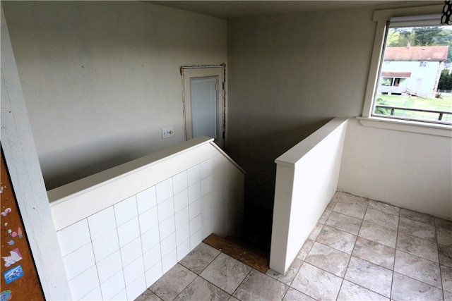 stairs featuring tile patterned flooring