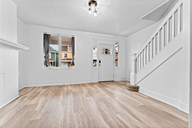 foyer entrance with light hardwood / wood-style flooring