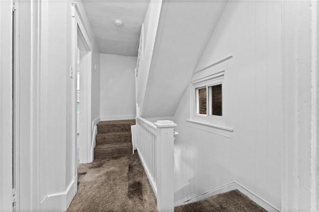 staircase featuring carpet and lofted ceiling