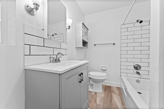 full bathroom with shower / bathing tub combination, wood-type flooring, vanity, and toilet