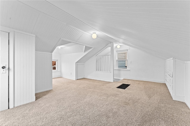 bonus room with carpet flooring and lofted ceiling