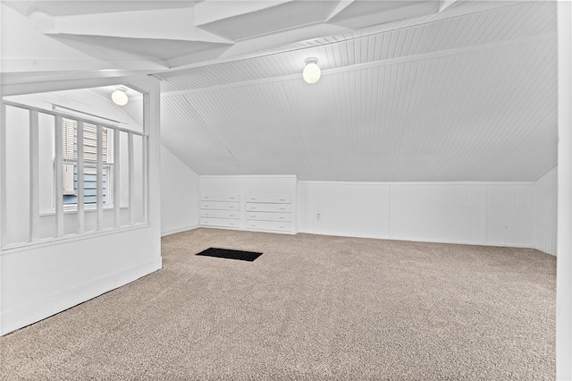 bonus room with lofted ceiling and carpet flooring