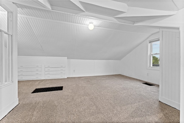 bonus room featuring carpet floors and vaulted ceiling