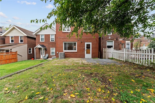 back of house with a lawn, a patio, and cooling unit