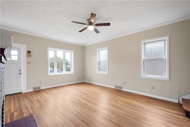 unfurnished living room featuring a textured ceiling, crown molding, ceiling fan, and light hardwood / wood-style flooring