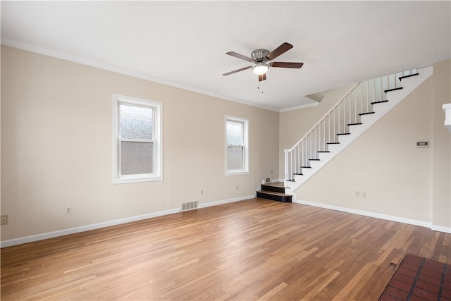 unfurnished living room featuring light hardwood / wood-style flooring, ceiling fan, and crown molding