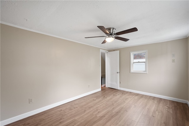 unfurnished room with a textured ceiling, ornamental molding, ceiling fan, and light hardwood / wood-style flooring