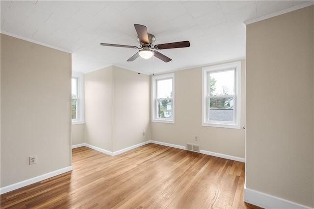 unfurnished room featuring ceiling fan, crown molding, and light hardwood / wood-style floors