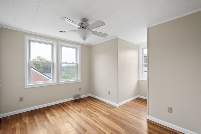 empty room featuring crown molding, ceiling fan, and light hardwood / wood-style flooring