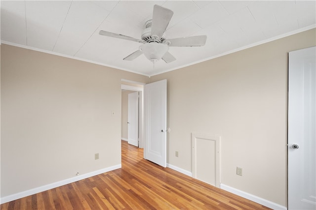 spare room featuring ceiling fan, hardwood / wood-style floors, and crown molding