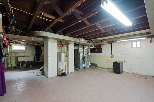 basement with gas water heater, sink, and heating unit