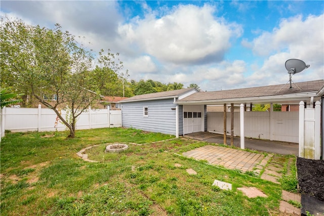 view of yard featuring a patio and an outdoor fire pit