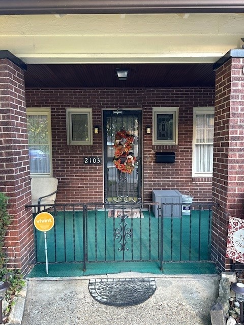 view of exterior entry with a porch