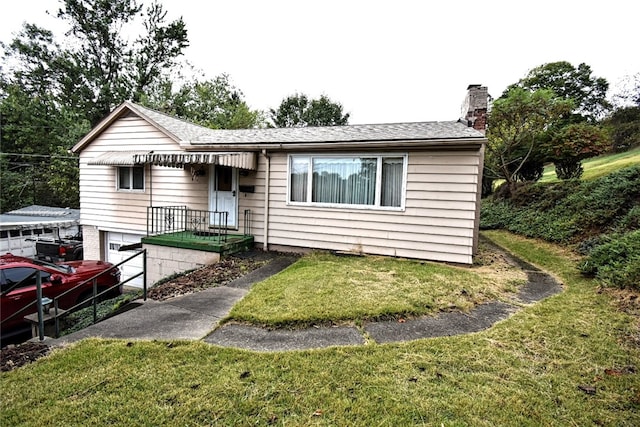 single story home with a front yard and a garage