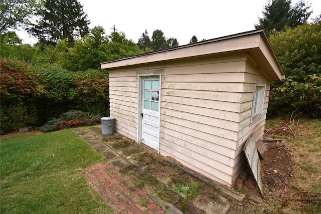 view of outbuilding featuring a lawn