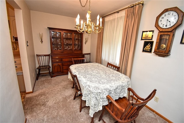 dining room with light carpet and a notable chandelier