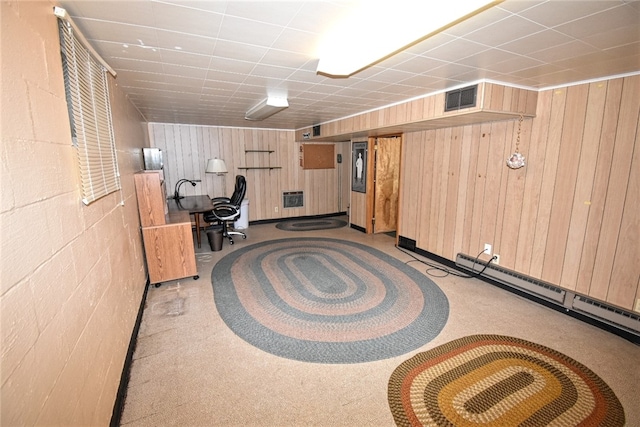 basement with wood walls and light colored carpet