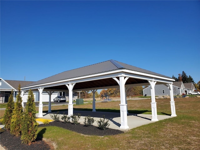 view of home's community with a lawn and a gazebo