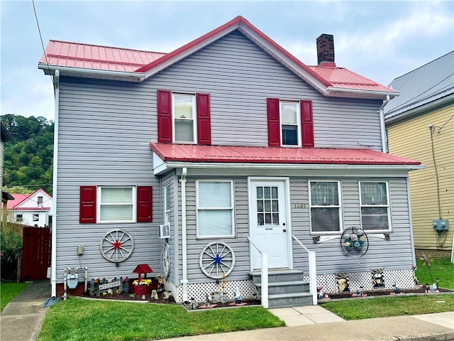 view of front of home featuring a front yard and cooling unit