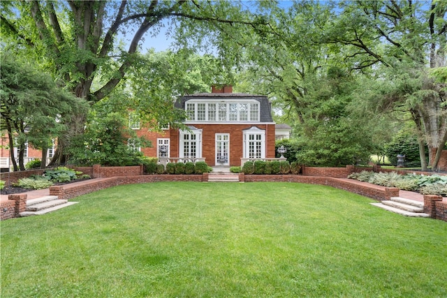 view of front of home featuring french doors and a front lawn