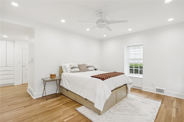 bedroom with ceiling fan and light hardwood / wood-style flooring