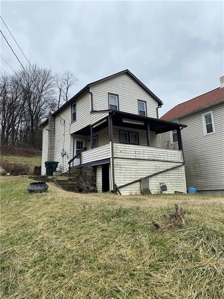 back of house featuring a lawn