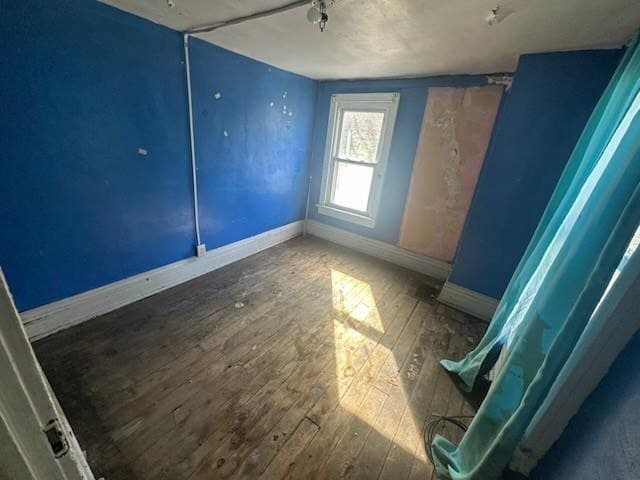 empty room with hardwood / wood-style flooring