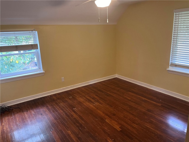 spare room featuring vaulted ceiling, ceiling fan, and dark hardwood / wood-style flooring