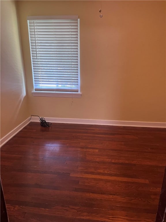 spare room with dark hardwood / wood-style flooring