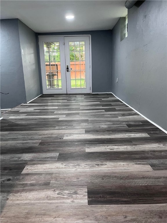 empty room featuring dark hardwood / wood-style floors and french doors